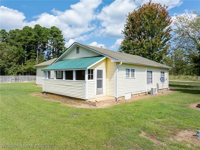 rear view of property with a lawn