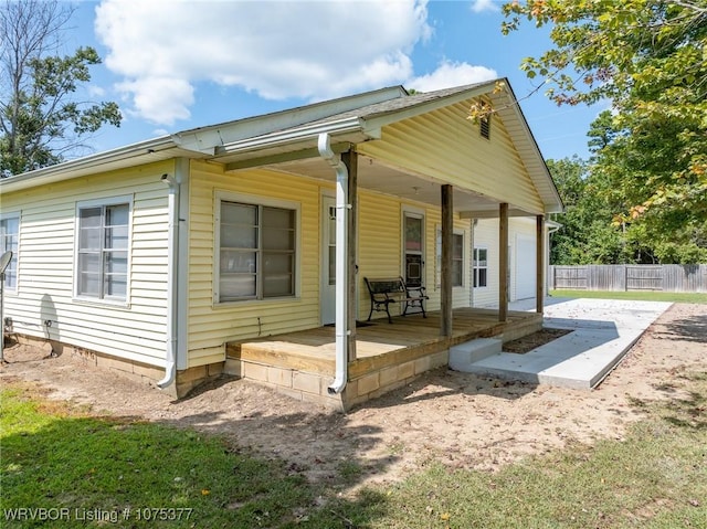 rear view of house featuring covered porch