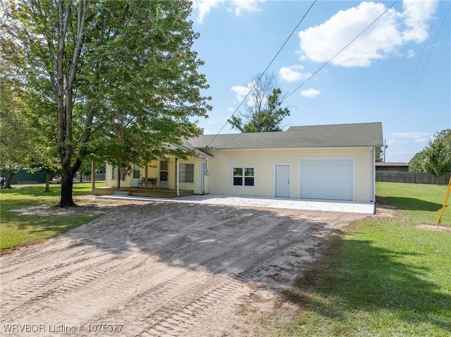 view of front of home featuring a front lawn, a porch, and a garage