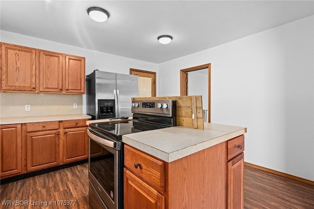 kitchen featuring dark hardwood / wood-style flooring and appliances with stainless steel finishes