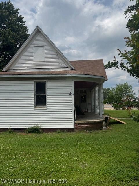 24 S 3rd St, Paris, AR 72855 - rear view of house featuring a lawn and a porch