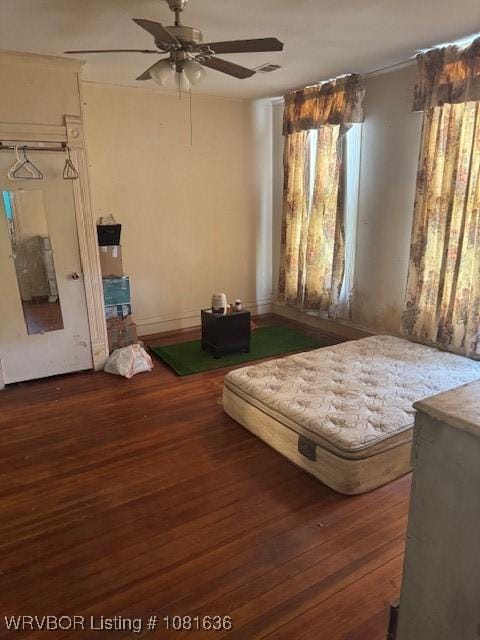 24 S 3rd St, Paris, AR 72855 - bedroom with multiple windows, wood finished floors, and ceiling fan
