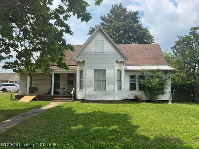 24 S 3rd St, Paris, AR 72855 - back of house with a porch and a lawn