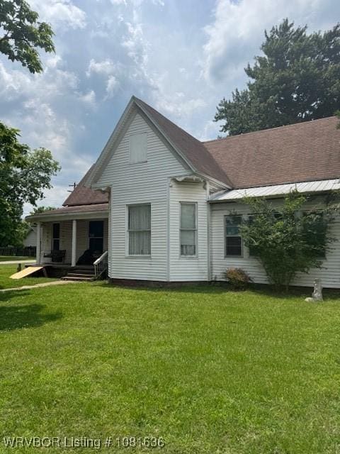 24 S 3rd St, Paris, AR 72855 - back of house with a lawn and covered porch