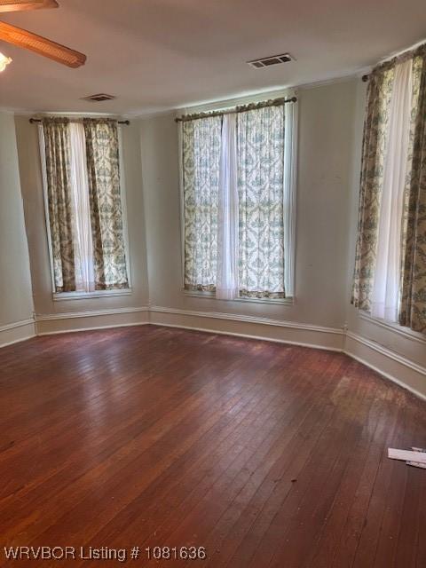 24 S 3rd St, Paris, AR 72855 - spare room with healthy amount of natural light, wood-type flooring, ceiling fan, and crown molding