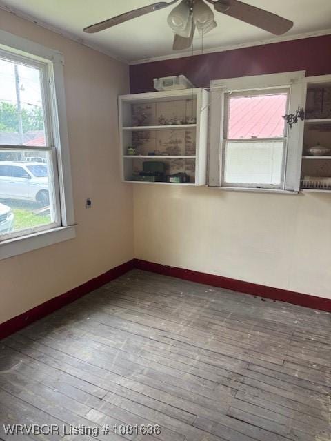 24 S 3rd St, Paris, AR 72855 - empty room with ceiling fan, plenty of natural light, hardwood / wood-style flooring, and ornamental molding
