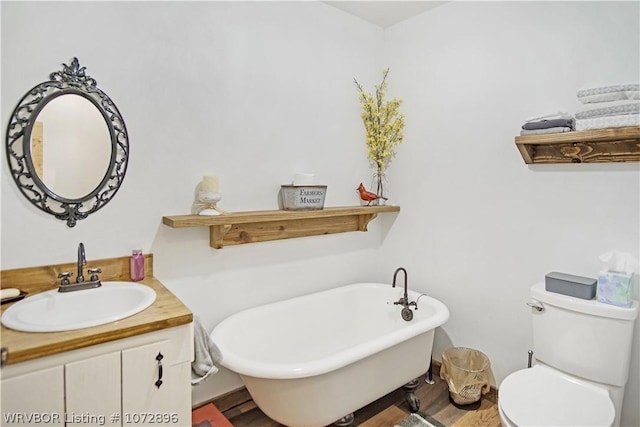 bathroom featuring a bath, vanity, and toilet