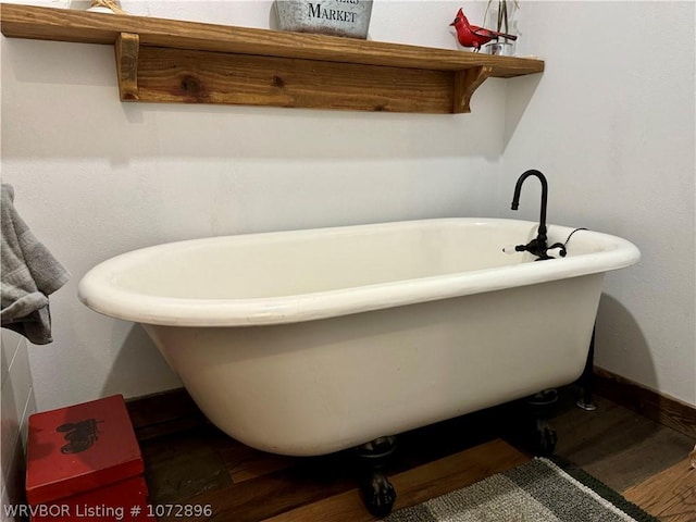 bathroom with a bathtub and wood-type flooring