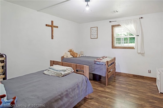 bedroom with dark wood-type flooring