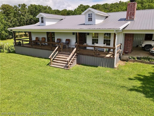 back of property featuring a lawn, covered porch, and french doors