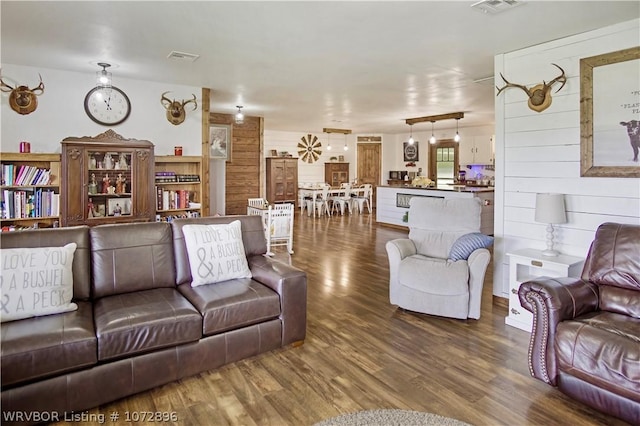 living room with hardwood / wood-style floors and wood walls