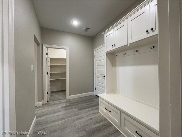 mudroom with light hardwood / wood-style flooring