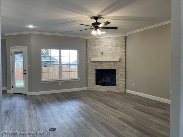 unfurnished living room with ceiling fan, crown molding, and a fireplace