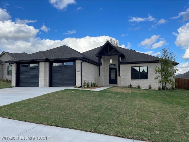 view of front of home with a garage and a front yard