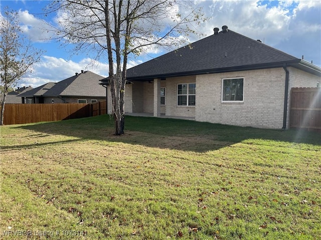 rear view of house with a lawn