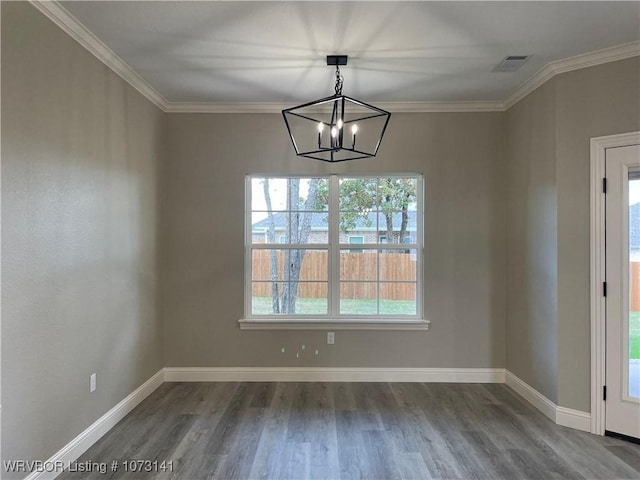 unfurnished dining area featuring a notable chandelier, wood-type flooring, plenty of natural light, and crown molding