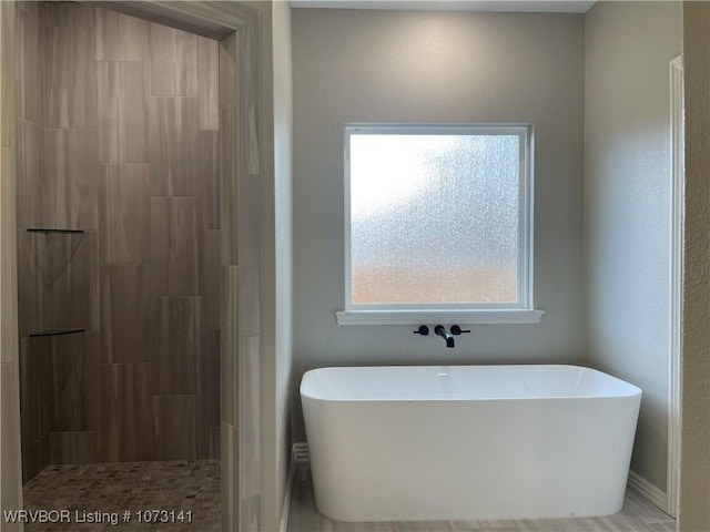 bathroom featuring plus walk in shower