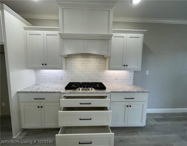 kitchen featuring hardwood / wood-style flooring, white cabinetry, stainless steel gas cooktop, and light stone counters