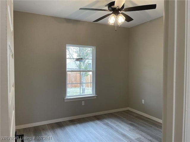 empty room featuring hardwood / wood-style flooring and ceiling fan