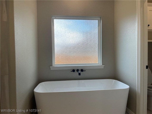 bathroom with a tub to relax in