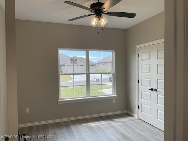 unfurnished room with ceiling fan and light hardwood / wood-style flooring