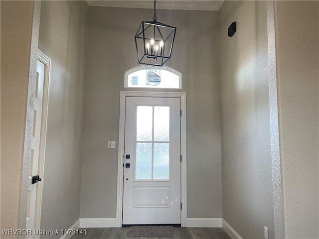 foyer entrance featuring a chandelier and hardwood / wood-style flooring