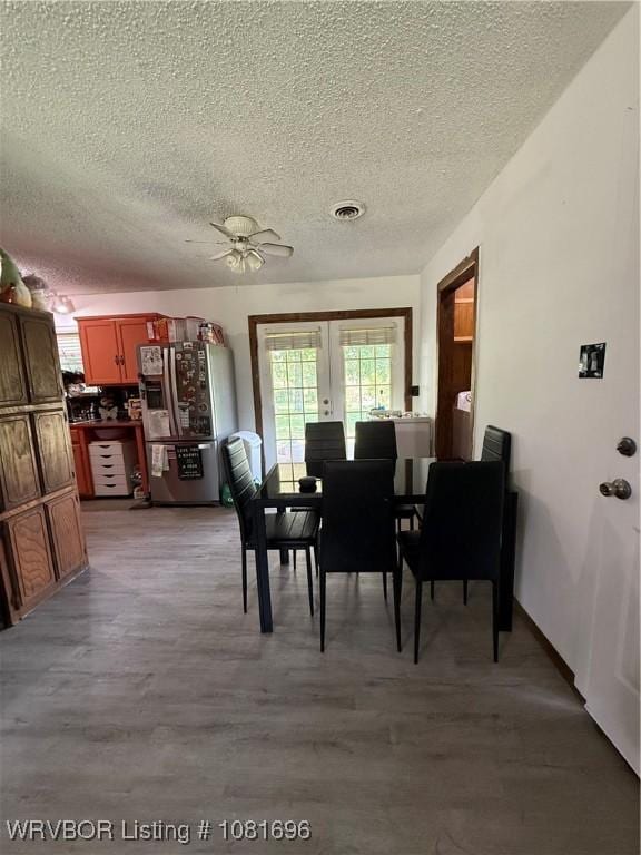 13824 Grober Hill Way, Fort Smith, AR 72916 - dining area featuring a textured ceiling, a ceiling fan, french doors, and light wood-type flooring
