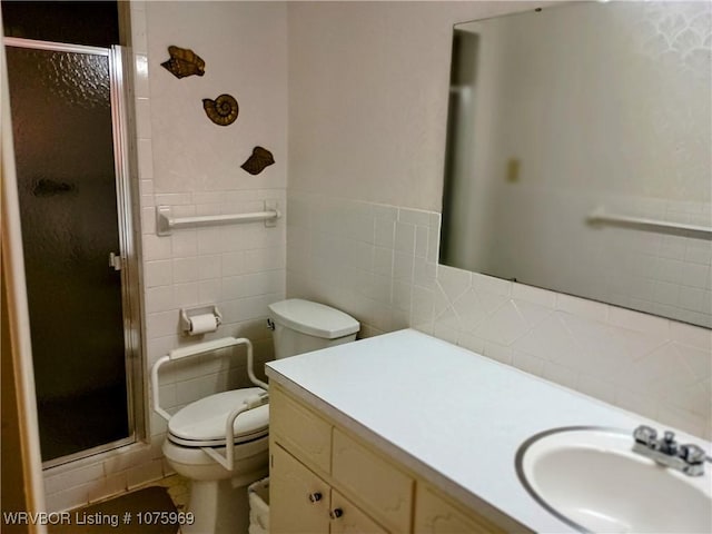 bathroom featuring vanity, toilet, an enclosed shower, and tile walls