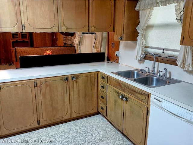 kitchen featuring white dishwasher and sink