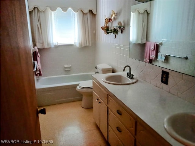 bathroom with vanity, toilet, and backsplash