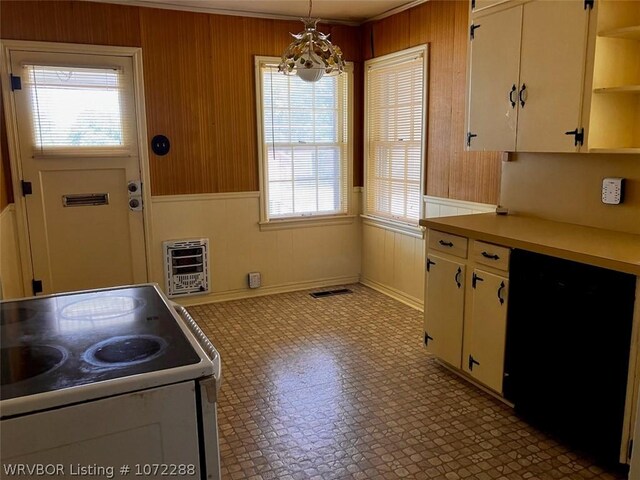 kitchen featuring heating unit, pendant lighting, white cabinets, range, and black dishwasher