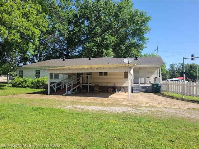 rear view of property with a yard