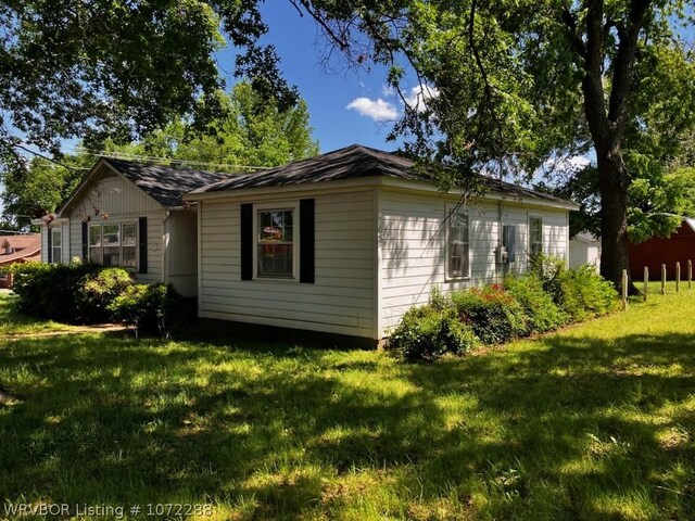 view of side of home with a lawn