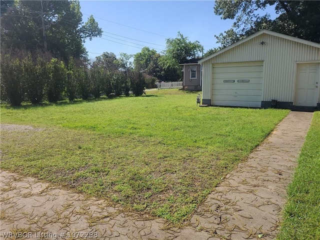 view of yard featuring an outbuilding and a garage