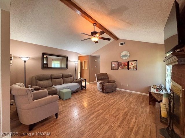 2114 Breckenridge Ter, Greenwood, AR 72936 - living area with light wood finished floors, ceiling fan, a textured ceiling, a fireplace, and baseboards
