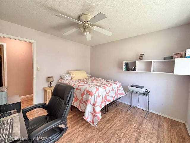 2114 Breckenridge Ter, Greenwood, AR 72936 - bedroom with wood finished floors, baseboards, a textured ceiling, and ceiling fan