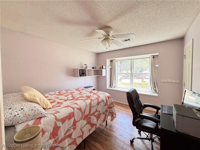 2114 Breckenridge Ter, Greenwood, AR 72936 - bedroom featuring hardwood / wood-style floors, a textured ceiling, a desk, and a ceiling fan
