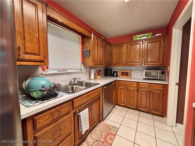 2114 Breckenridge Ter, Greenwood, AR 72936 - kitchen with a sink, stainless steel dishwasher, light countertops, brown cabinets, and a textured ceiling