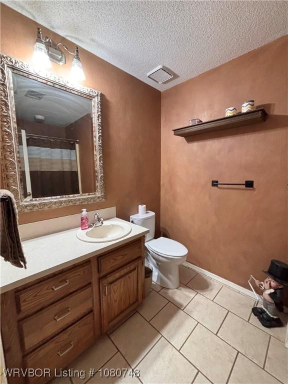 2114 Breckenridge Ter, Greenwood, AR 72936 - full bathroom with a textured ceiling, tile patterned flooring, vanity, toilet, and curtained shower