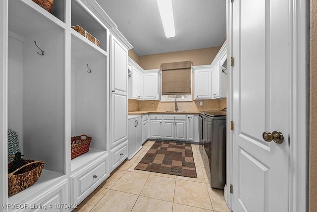 mudroom featuring sink and light tile patterned flooring