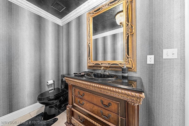 bathroom with tile patterned floors, vanity, toilet, and crown molding