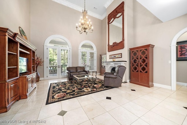 living room featuring french doors, crown molding, an inviting chandelier, a high ceiling, and light tile patterned flooring