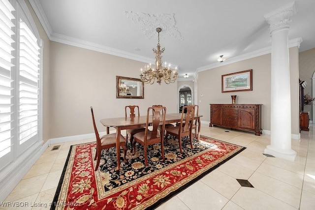 dining area featuring ornate columns, crown molding, light tile patterned floors, and a notable chandelier