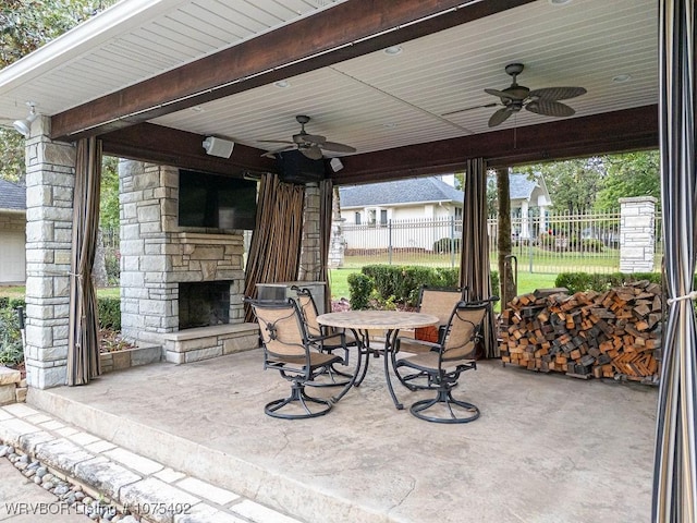 view of patio / terrace with an outdoor stone fireplace and ceiling fan