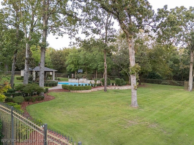 view of property's community with a gazebo, a pool, and a lawn