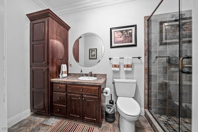 bathroom featuring vanity, toilet, a shower with door, and crown molding