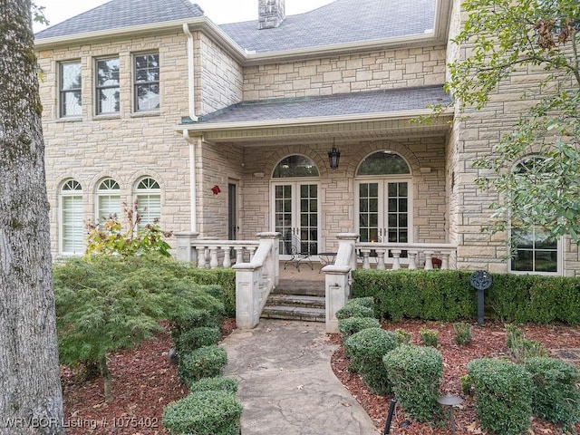 property entrance featuring french doors and a porch