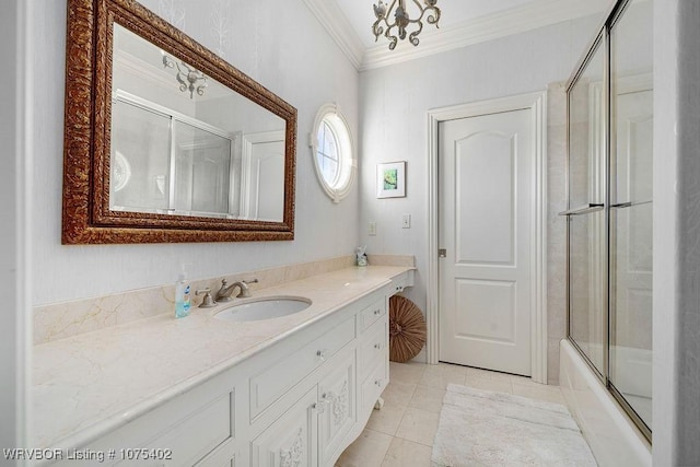 bathroom with vanity, tile patterned flooring, enclosed tub / shower combo, ornamental molding, and a notable chandelier