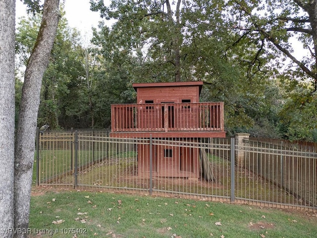 exterior space with a deck and a lawn