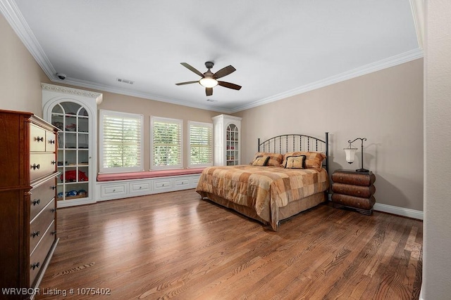 bedroom with hardwood / wood-style flooring, ceiling fan, and crown molding